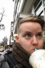 A selfie of Malcom walking down the street drinking bubble tea on a chilly, wet day.