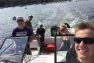 Tom looks happy with a group of friends lounging on a boat on a bright sunny day.