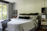 Pendant lights open up surface space on small bedside tables, while mirrors behind them fool the eye into experiencing the space as larger than it is. – North Beach Refresh – Board & Vellum