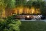 Tall fencing, layered plantings, and gabion blocks form the edge of an outdoor room anchored with a fire pit to take the chill off cool nights. – North Beach Refresh – Board & Vellum landscape architecture.