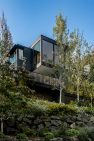 The house perches above the street, sheltered by landscaped terraces of stacked stone. – Laurelhurst Landscape at the Tree+House – Board & Vellum