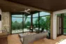 An architectural rendering of a treehouse rental home interior, with large windows looking out to the surrounding forest.