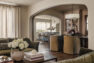 A view from the home’s sitting room into the formal dining room and kitchen beyond. Parabolic arched framed openings separate each room.