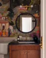 A bold powder room with bright wallpaper showing a jewel-toned scene of animals, plants, people, and buildings called The Gardens of Jaipur. Serene Modern Tudor — Board & Vellum