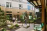 Wide view of the central courtyard framed by interior-facing units at Tanager Apartments. – Tanager Apartments – Board & Vellum