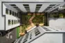 The central courtyard viewed in plan from above shows the plantings and boardwalk path angling through the space. – Tanager Apartments – Board & Vellum