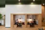 Built-in booth seating in the resident lounge at Tanager Apartments feature plush seating and woodland wallpaper.. – Tanager Apartments – Board & Vellum