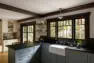 Windows above the farm sink open the kitchen to the garden, with soapstone counters, brass brackets on open shelves, and the banquette and coffee bar beyond. – Tangletown Craftsman – Interior Design for a Craftsman Home – Board & Vellum