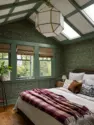 The primary bedroom's vaulted ceiling features painted beams, new skylights, and a statement geometric lantern chandelier. - Tangletown Craftsman – Interior Design for a Craftsman Home – Board & Vellum