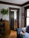Original fir casing frames the view from the family room into the small vestibule that holds the basement stairs, paneled and fitted with casework on the way to the kitchen. - Tangletown Craftsman – Interior Design for a Craftsman Home – Board & Vellum