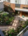 Boardwalk path through the planted central courtyard at Tanager Apartments. – Tanager Apartments – Board & Vellum