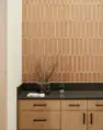 A tiled backsplash in the amenity lounge rises from the counter to the ceiling. Tanager Apartments – Board & Vellum