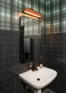 Shared amenity restroom at Tanager Apartments with Pacific Northwest-inspired finishes. – Tanager Apartments – Board & Vellum