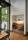 A built-in banquette niche in the co-working lounge adds to seating options with a view to the streetscape beyond. – Tanager Apartments – Board & Vellum