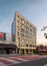 The façade of Tanager Apartments on East Madison as shown from across the street, showing the RapidRide bus line. – Tanager Apartments – Board & Vellum