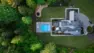An aerial view of a home with a new pool and designed backyard. Woodinville Backyard Retreat – Residential Landscape Architecture – Board & Vellum